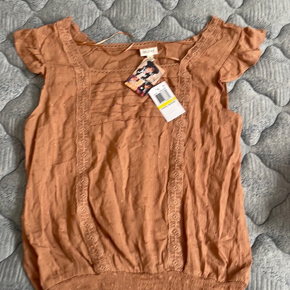 Medium top but fits and looks like a small .